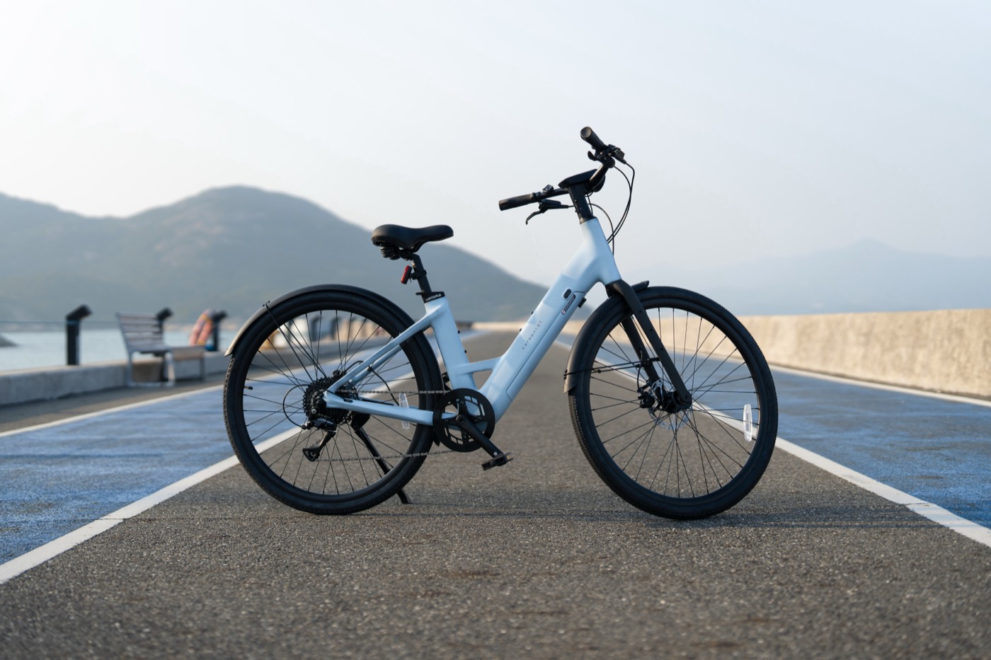 An Urtopia Carbon 1 ST parked on a waterfront causeway