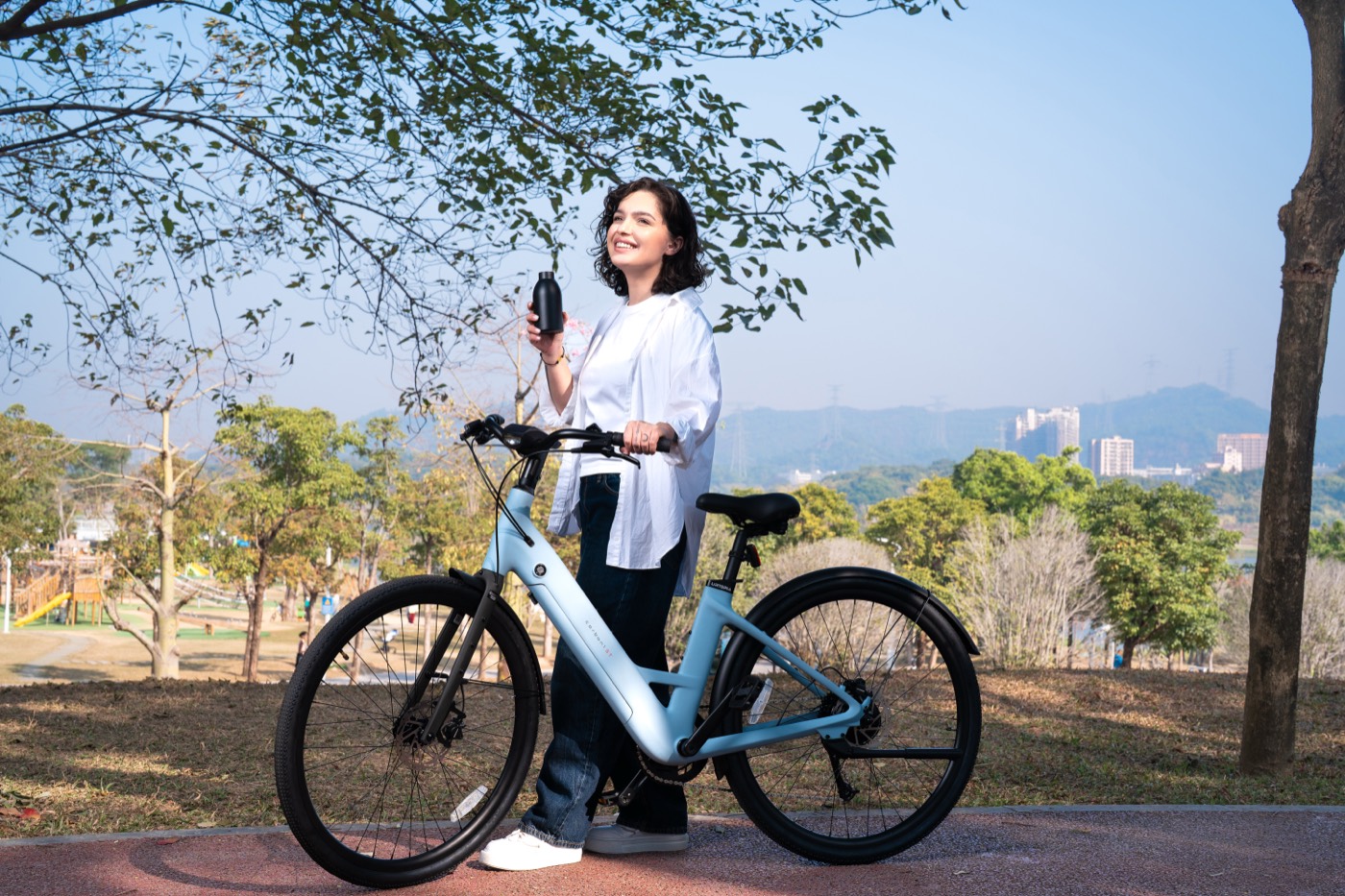 A rider standing beside an Urtopia Carbon 1 ST in a park